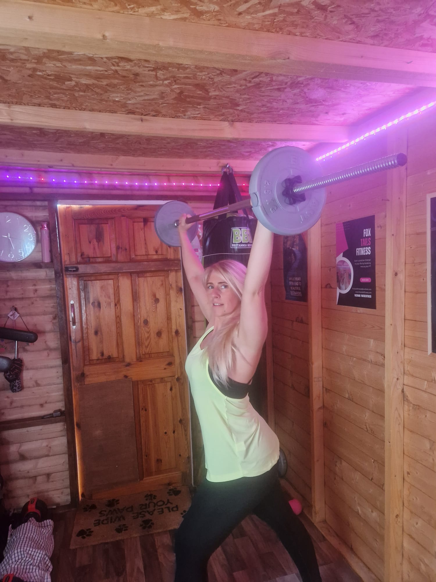 Danielle holding a barbell overhead in the Foxtail Fitness studio
