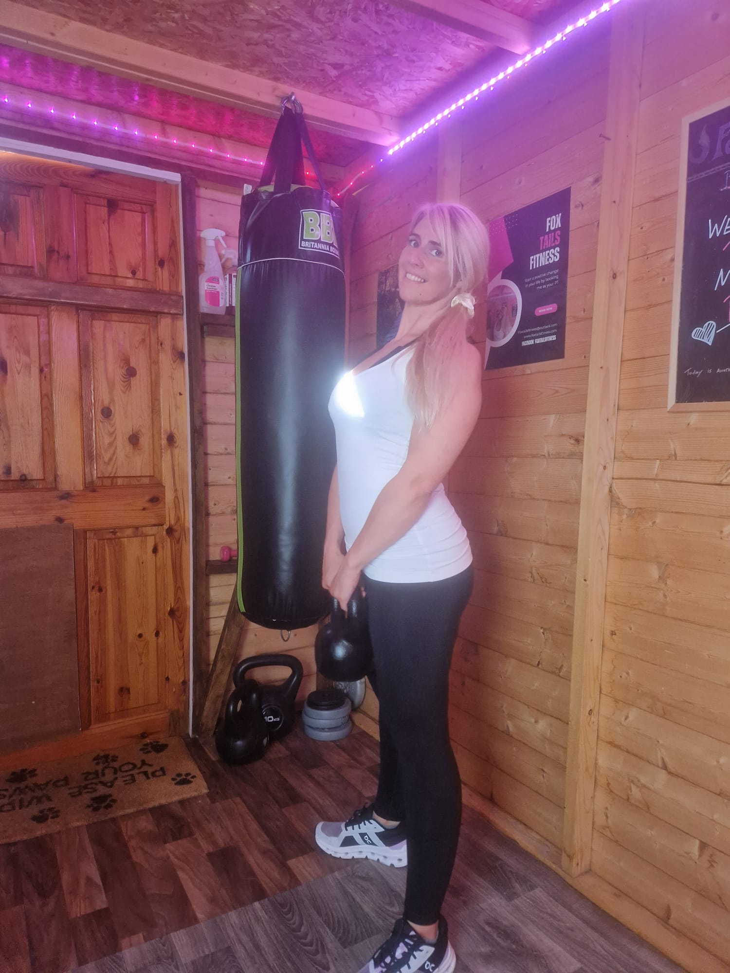 Danielle in the Foxtail Fitness studio beside kettlebells and a punch bag